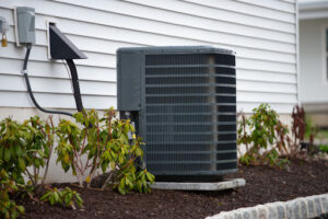 An outdoor air conditioning unit installed outside of a home.
