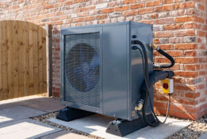An outdoor heat pump unit installed on a concrete slab.