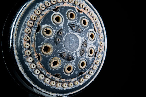 White mineral buildup on showerhead.