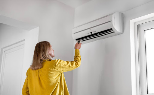 Woman checking why AC is turning on and off.